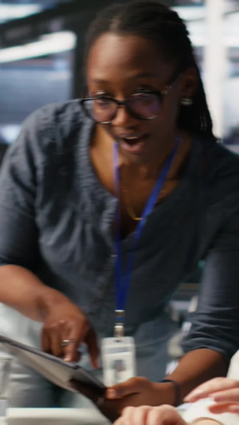 Vertical video Smiling technicians doing fist bump in AI data center Stock Footage 309486454