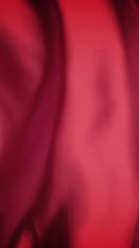 Vertical video: Soft breeze moving red satin fabric, folds sliding and light Stock Footage 348567982