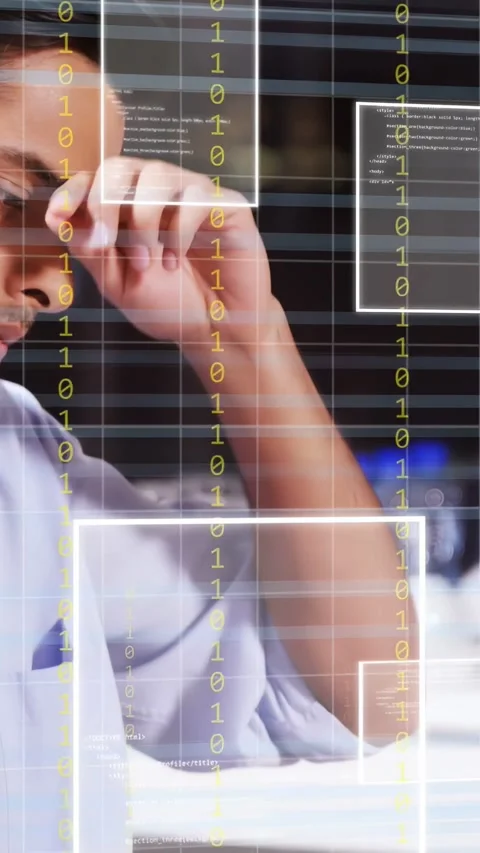 Vertical video: Software dev typing on laptop at counter, input causing binary Stock Footage 333496685