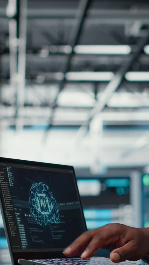 Vertical video Software developer in data center uses AI technology on laptop Stock Footage 311413864
