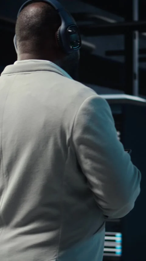 Vertical video Software developer in data center workspace coding on tablet Stock Footage 311490163