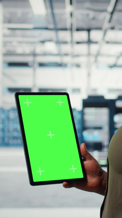 Vertical video Software developer in data center using green screen tablet Stock Footage 317054037