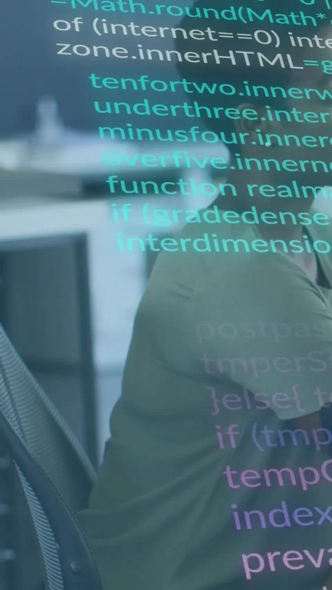 Vertical video: Software developer at desk debugging, monitor scrolling code Stock Footage 334386732