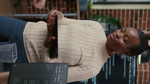 Vertical video Software developer standing up holding digital tablet talking Stock Footage 194148499