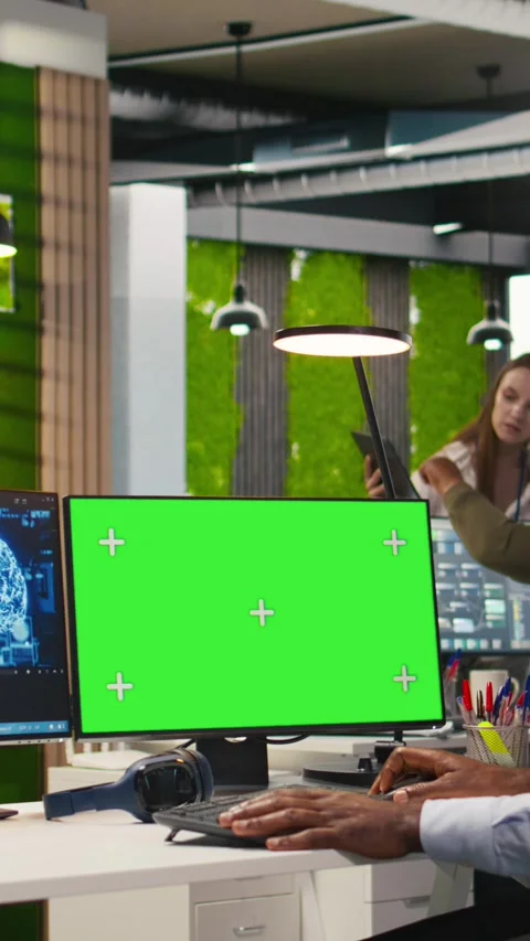 Vertical video Software developer using AI on green screen computer to optimize Stock Footage 312768905