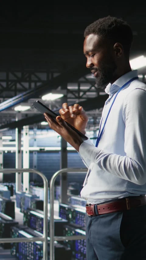 Vertical video Software developers on data center industrial platform analyzing Stock Footage 310776375