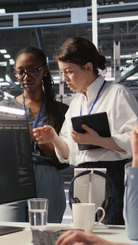Vertical video Software developers working together in server farm, reviewing AI Stock Footage 309486848