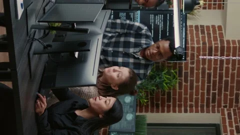 Vertical video Software engineers brainstorming ideas looking at code on Stock Footage 194149419