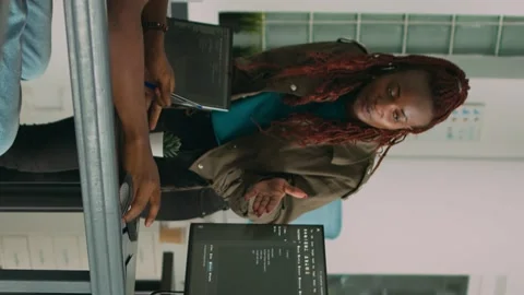 Vertical video: Software engineers brainstorming ideas to develop it code on Stock Footage 220160782
