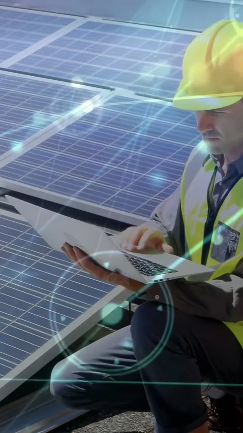 Vertical video: Solar tech kneeling on roof, opening laptop and checking data Stock Footage 334317366