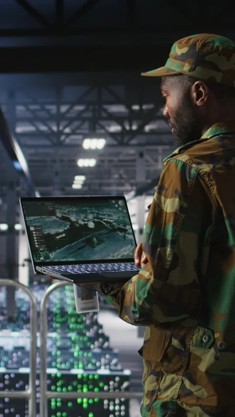 Vertical video Soldier in server room uses geospatial data to support emergency Stock Footage 310773074