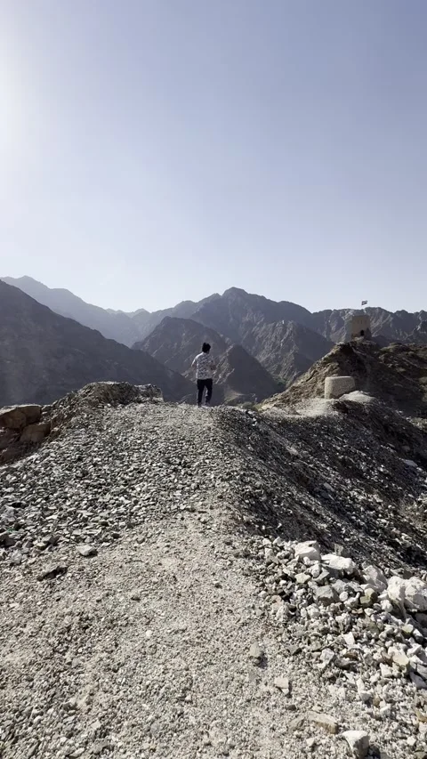 Vertical Video: Solo Content Creator Running On Mountain Peak With UAE Watchtowe Stock Footage 342581800