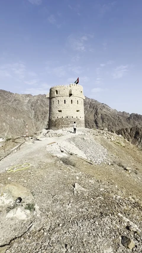Vertical Video: Solo Content Creator Running On Mountain Peak With UAE Watchtowe Stock Footage 342581810