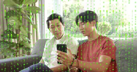 Vertical video: Son rotating phone, father leaning, sharing screen, smiling Stock Footage 330713279