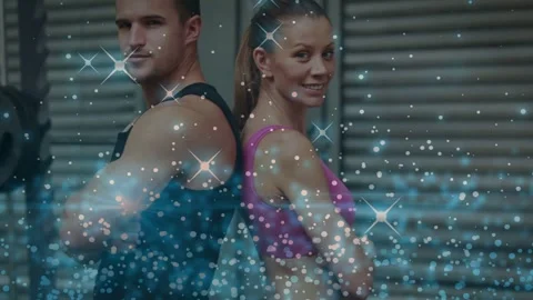 Vertical video: Sparkle cueing reveal, pair posing then smiling giving thumbs-up Stockbeeldmateriaal 334040889