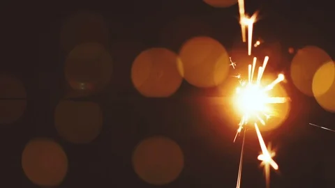 Vertical video of sparkler in slow motion. Warm bokeh Stock Footage 115370819