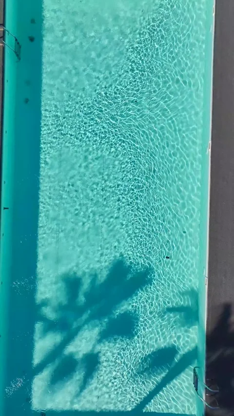 Vertical Video of a Sparkling Pool Captured From Above With Clear Blue Water and Video stock 300343294