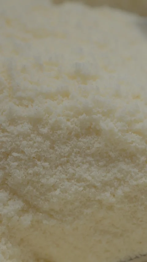 Vertical video Spoon filled with smooth powdered milk ready for cooking and Stock Footage 329618609