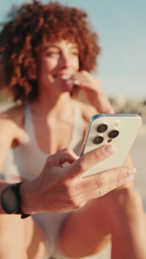 Vertical video, Sportswoman Using Smartphone After Workout Stock Footage 317568585