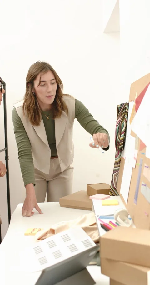 Vertical video: Spotting charts Diverse female colleagues circling prints Stock Footage 345320585