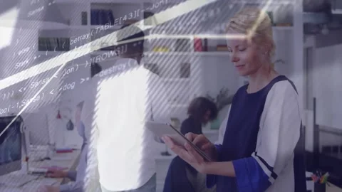 Vertical video: Standing woman tapping tablet in tech office, initiating charts Stock Footage 334184880