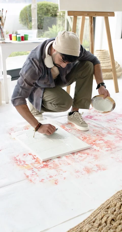 Vertical video: At start man is scooping plaster, spreading across canvas by Stock Footage 346718759