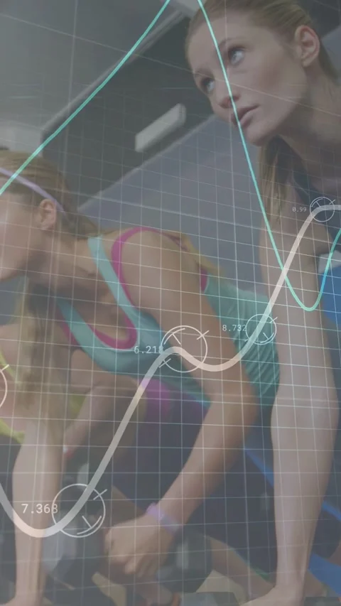 Vertical video: At start two women cycling in fitness studio, animated graphs Stock Footage 333021037