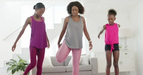 Vertical video: Starting left girl swinging arms mom guiding ankle hold Stock Footage 342392844