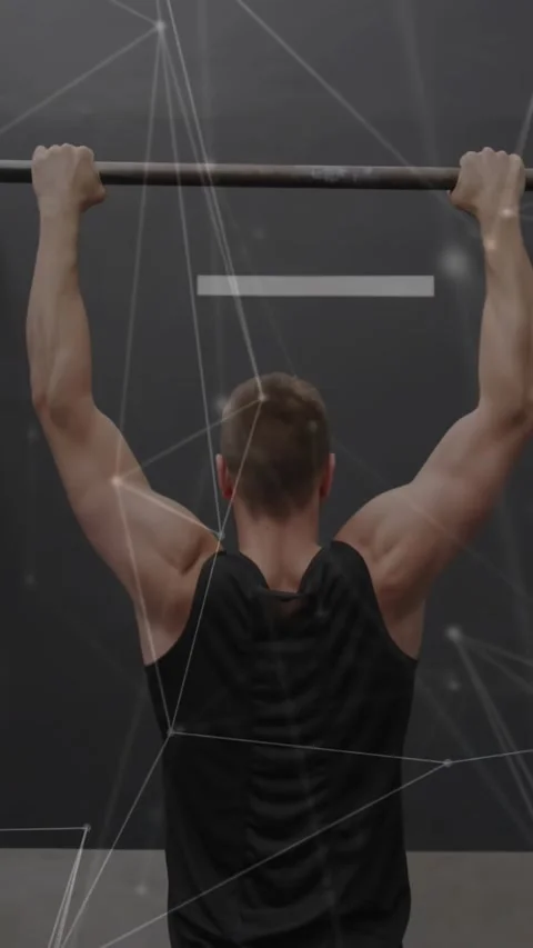 Vertical video: Starting from top, man in tank doing pull-ups on bar at gym for Stock Footage 332407885