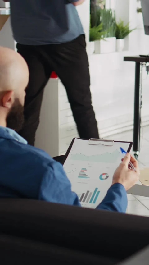Vertical Video Startup analyst comparing files Stock Footage 243724716