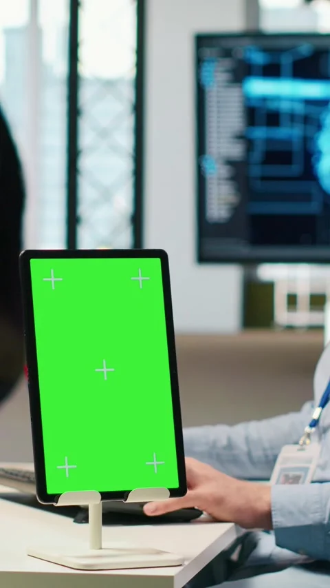 Vertical video Startup technician using isolated screen tablet, developing AI Stock Footage 312708099