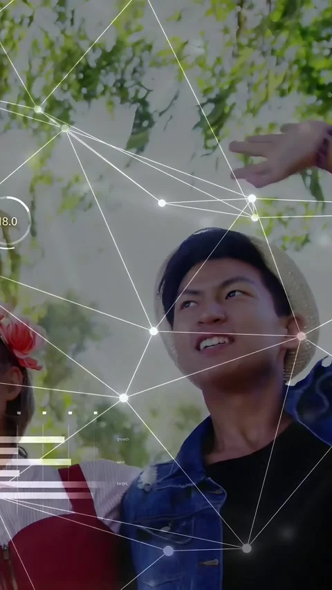 Vertical video: Straw-hatted man looking up raising arm under tree making tech Stock Footage 333487106