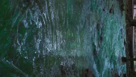 Vertical video, a stream of waterfalls flowing through the rocks. The water is c Stock Footage 210160508
