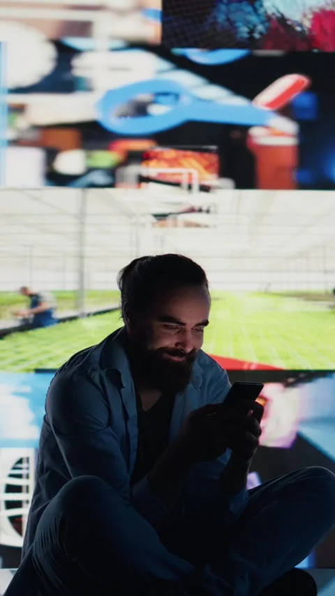 Vertical Video Stressed individual obsessively overuses his mobile phone social Stock-Footage 310702573