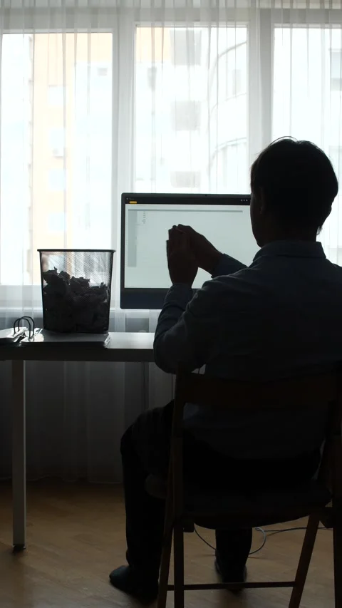 Vertical video stressed office worker sitting at a desk with a computer Stock Footage 345529851