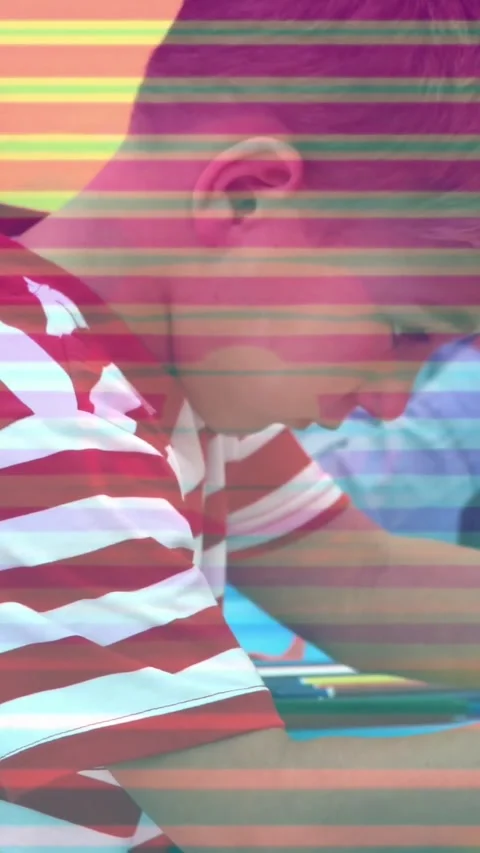 Vertical video: Striped boy starting class task after prompt writing while Stock Footage 333835657
