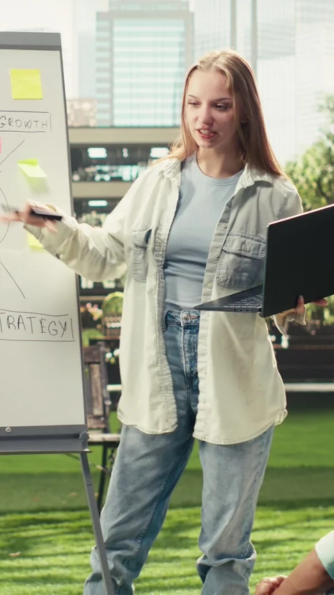Vertical Video Student explaining strategy whiteboard to classmates on outdoor 스톡 동영상 341316466