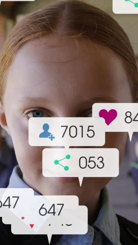 Vertical video: Student facing lens after one second social icons popping over Stock Footage 331238080