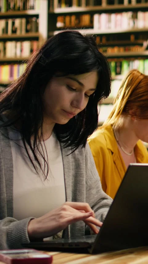 Vertical Video Student ignoring laptop work and notes after phone notification Stock Footage 336379278