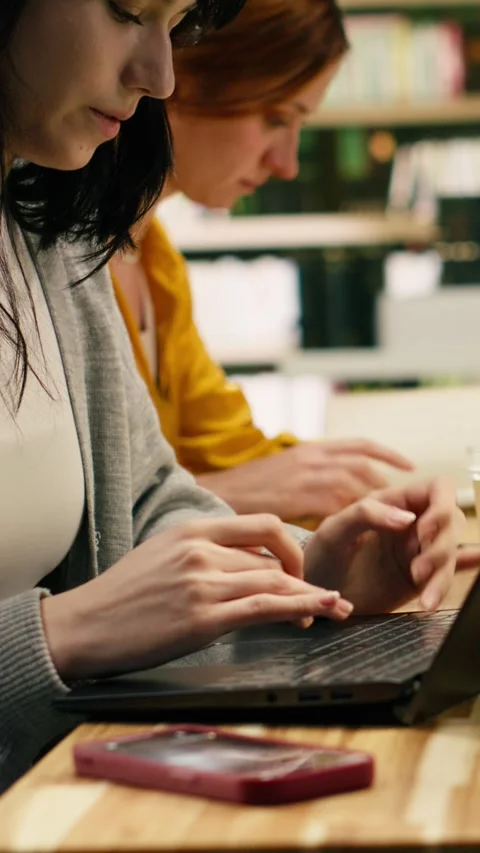 Vertical Video Student ignoring laptop work and notes after phone notification Stock Footage 336380515
