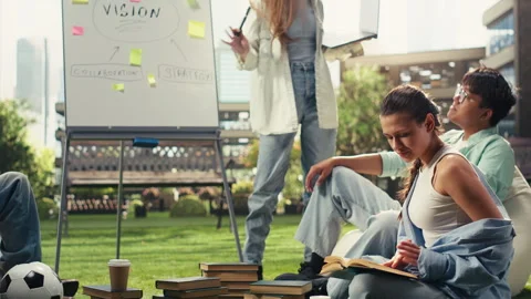 Vertical Video Student reading open book during group study tutoring session Stock Footage 340794978