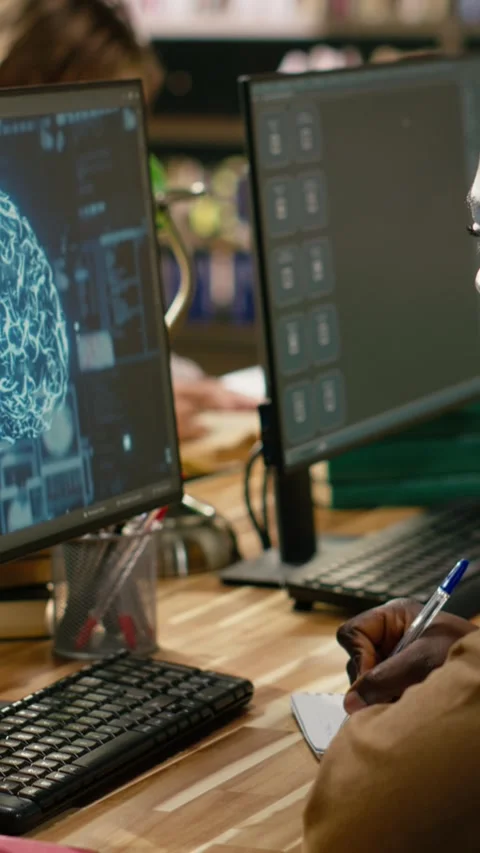 Vertical Video Student using AI brain on desktop and studying in library Stock Footage 337530891