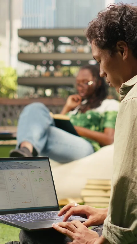 Vertical Video Student working with renewable energy data on laptop Stock Footage 341321178
