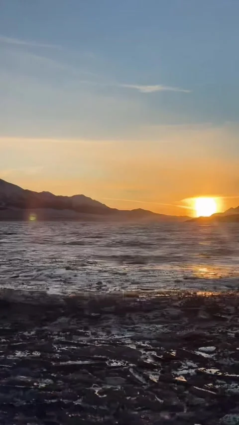 Vertical Video of Stunning Winter Sunrise and Floating Blue Ice on Sayram La Stock-Footage 328389595