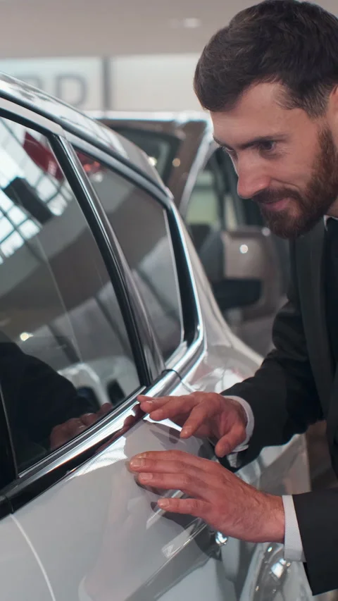 Vertical Video Stylish man is choosing new automobile walking around Stock Footage 337881542
