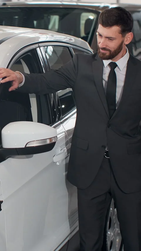 Vertical Video Stylish man is choosing new automobile walking Stock Footage 337882171