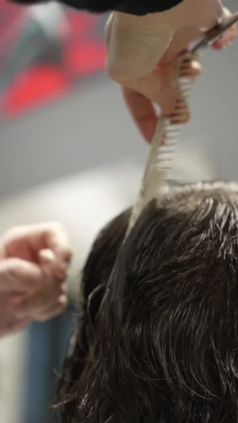 Vertical video: Stylish man sitting barbershop hairdresser woman cutting hair Stock Footage 271584695