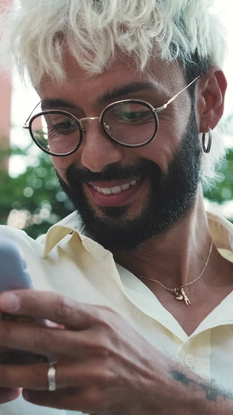 Vertical video, Stylish Man Smiles While Using His Phone Outdoors Stock Footage 314268244