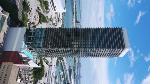 Vertical video of stylish multistorey building rising up against Miami harbor Stock Footage 254577692