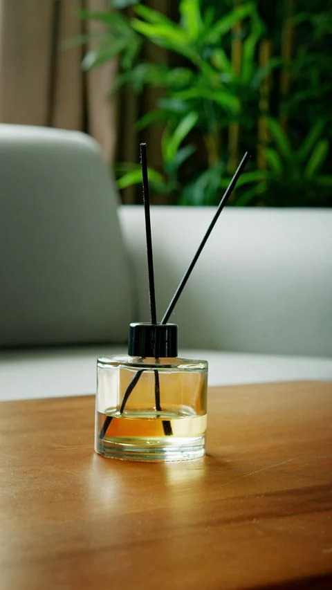 Vertical video. A stylish reed diffuser on a wooden table in a contemporary.. Stock Footage 296878379